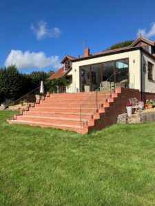Completed Chew Stoke home extension with brick garden steps, glass balustrades and handrails by Lees Builders