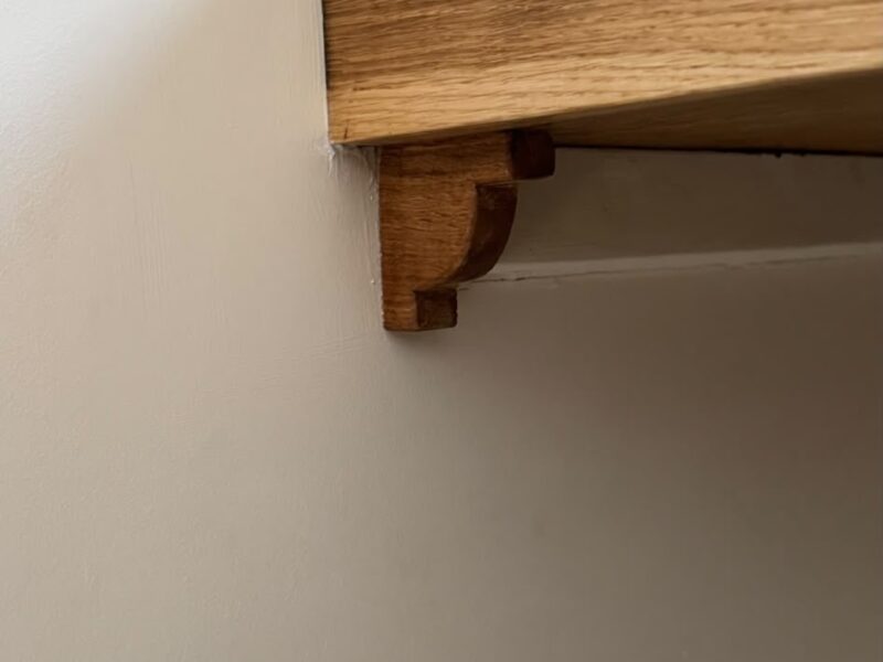 Shaped timber support bracket beneath the oak bar worktop
